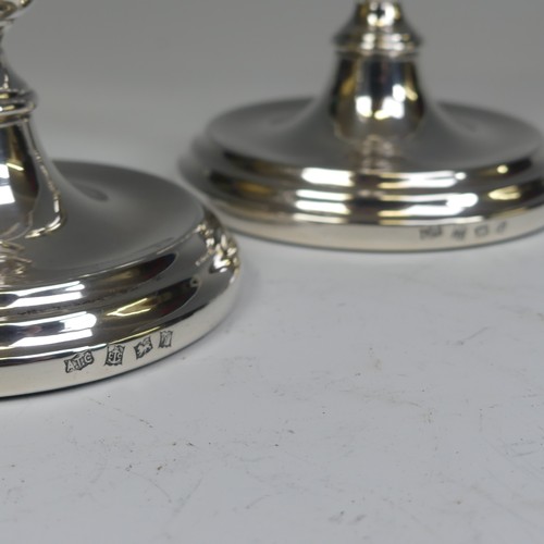 29 - A pair of Elizabeth II silver Candlesticks, by A T Cannon Ltd., hallmarked Birmingham, 1973, with we... 