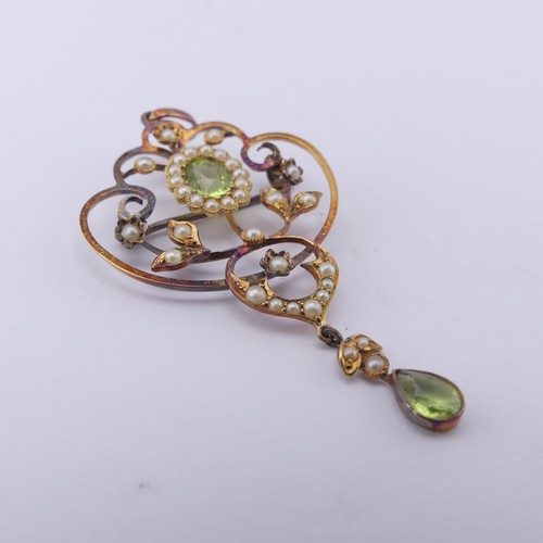 239 - An Edwardian peridot and seed pearl Pendant, in the Art Nouveau style, the central oval facetted per... 