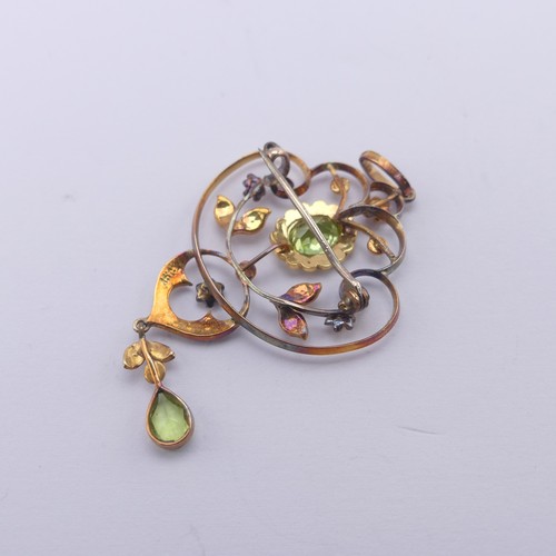 239 - An Edwardian peridot and seed pearl Pendant, in the Art Nouveau style, the central oval facetted per... 