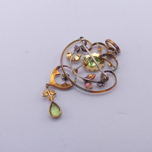 239 - An Edwardian peridot and seed pearl Pendant, in the Art Nouveau style, the central oval facetted per... 