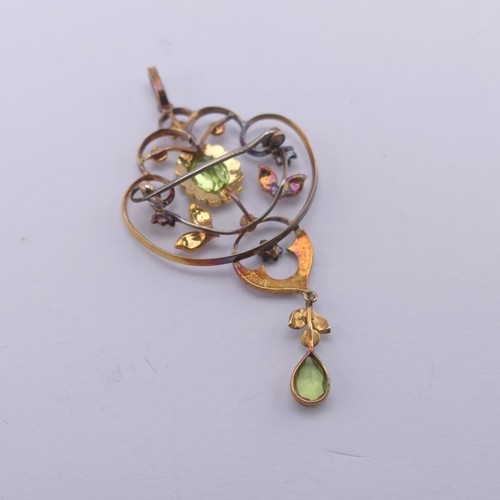 239 - An Edwardian peridot and seed pearl Pendant, in the Art Nouveau style, the central oval facetted per... 