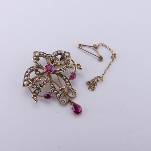 236 - An Edwardian pink sapphire and seed pearl Pendant / Brooch, of Art Nouveau design with three millegr... 