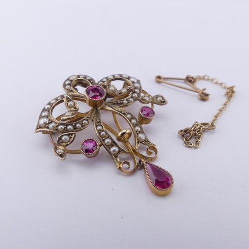 236 - An Edwardian pink sapphire and seed pearl Pendant / Brooch, of Art Nouveau design with three millegr... 