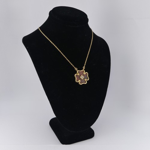 244 - An 18ct yellow gold clover Pendant, with tortoiseshell ground, with central diamond approx. 0.13ct, ... 