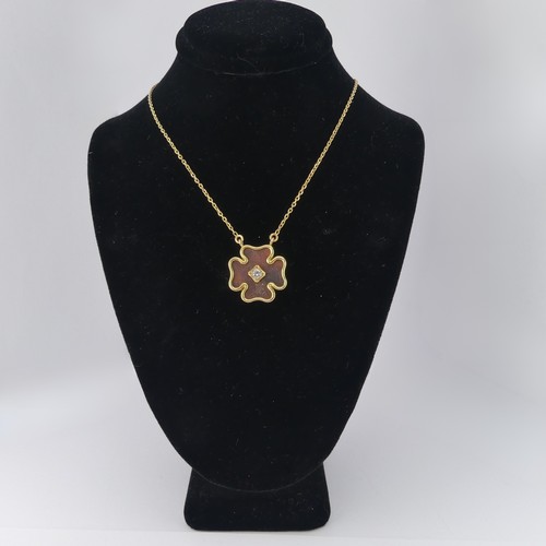 244 - An 18ct yellow gold clover Pendant, with tortoiseshell ground, with central diamond approx. 0.13ct, ... 