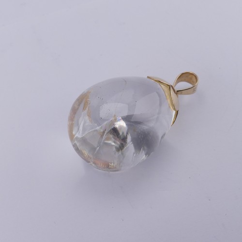 242 - A large pear shaped rock crstal Pendant, mounted in 9ct yellow gold, marked 375 and initialled 'M', ... 