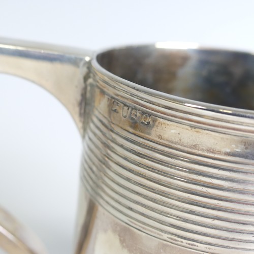 78 - A George III silver Mug, hallmarked London, 1811, makers mark unclear, of circular form with two ban... 