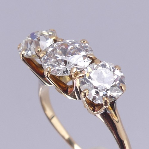 214 - A three stone diamond Ring, the central brilliant cut stone approx. 1.5ct with the outer stones each... 