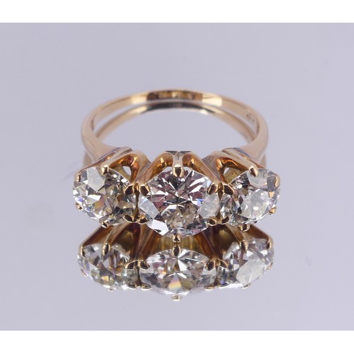 214 - A three stone diamond Ring, the central brilliant cut stone approx. 1.5ct with the outer stones each... 