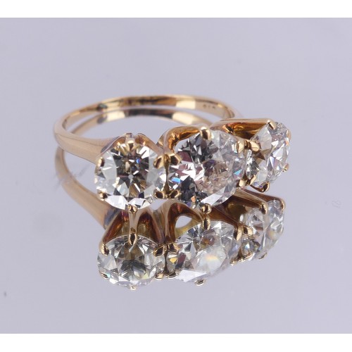 214 - A three stone diamond Ring, the central brilliant cut stone approx. 1.5ct with the outer stones each... 