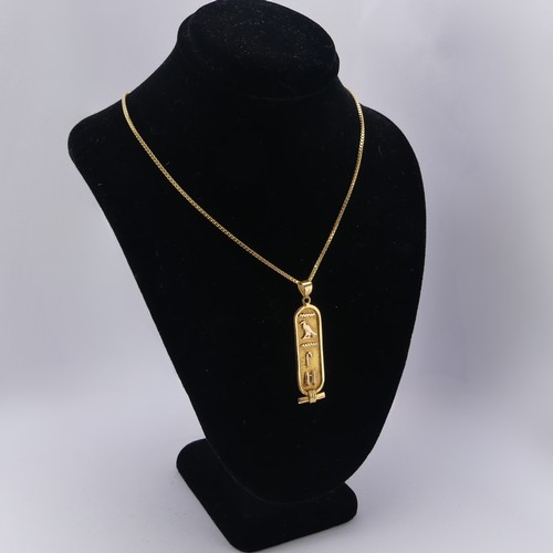 249 - A 18ct yellow gold Egyptian Hieroglyph Pendant, 4.3cm long, on an 18ct gold box link chain, 55cm lon... 