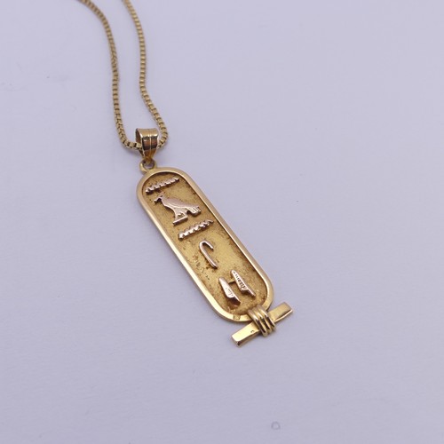 249 - A 18ct yellow gold Egyptian Hieroglyph Pendant, 4.3cm long, on an 18ct gold box link chain, 55cm lon... 