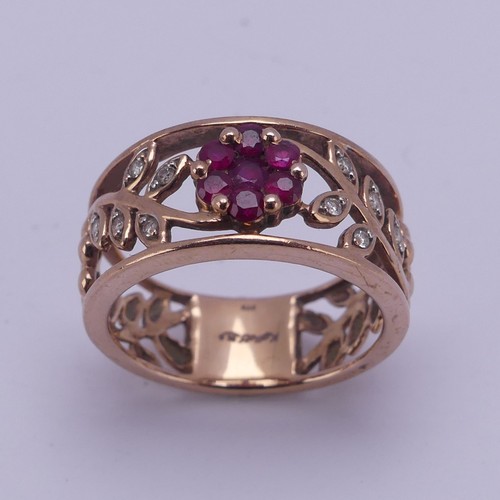 153 - A 9ct rose gold foliate pierced Ring, the front with ruby set flower head with diamond point set lea... 