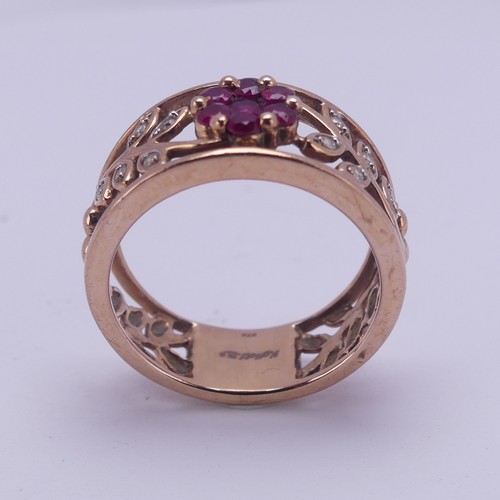 153 - A 9ct rose gold foliate pierced Ring, the front with ruby set flower head with diamond point set lea... 