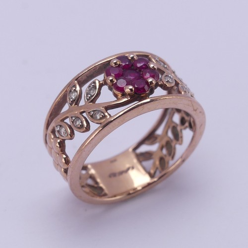 153 - A 9ct rose gold foliate pierced Ring, the front with ruby set flower head with diamond point set lea... 