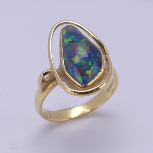 155 - An abstract opal Ring, collet set in 18ct yellow gold, Size Q, 5.8g.