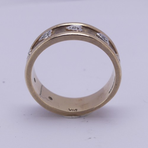 156 - A 9ct yellow gold Band, the textured centre with seven applied white gold hearts set small diamond p... 