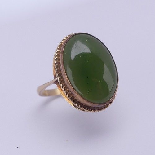 158 - A 9ct gold mounted jade Ring, the oval cabochon stone approx. 18mm long, in twist mount, Size O½, 4.... 