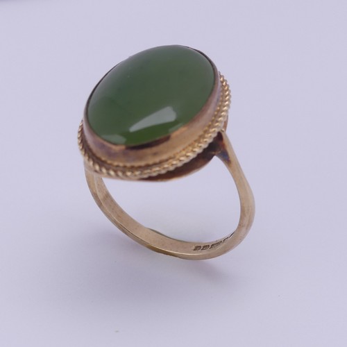 158 - A 9ct gold mounted jade Ring, the oval cabochon stone approx. 18mm long, in twist mount, Size O½, 4.... 