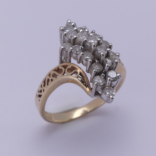 215 - A diamond cluster Dress Ring, the swirl front claw set with nineteen small brilliant cut stones, eac... 