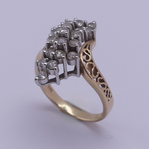 215 - A diamond cluster Dress Ring, the swirl front claw set with nineteen small brilliant cut stones, eac... 