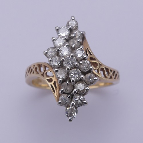 215 - A diamond cluster Dress Ring, the swirl front claw set with nineteen small brilliant cut stones, eac... 