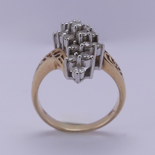 215 - A diamond cluster Dress Ring, the swirl front claw set with nineteen small brilliant cut stones, eac... 