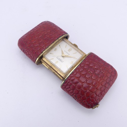 130 - A vintage Komos Purse Watch, with 17-jewels crown wind movement, red leather case, 5.5cm long closed... 