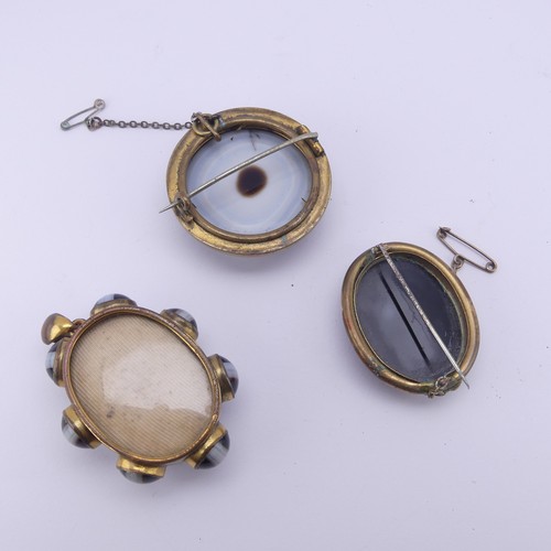 252 - A 19thC gilt metal mounted banded agate mourning  Pendant, the central oval stone 3.5cm long with sm... 