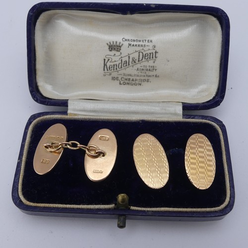 357 - A cased pair of 9ct gold oval Cufflinks, each side with engine turned decoration, chain between, app... 