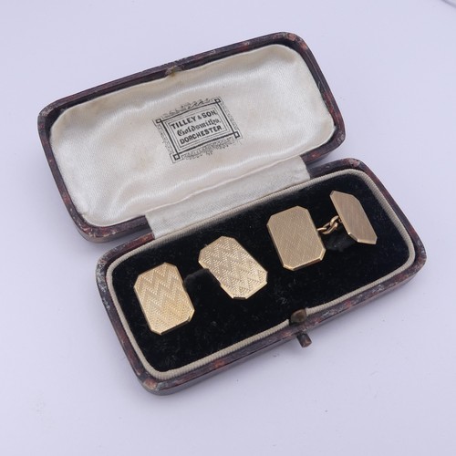 358 - A cased pair of 9ct gold Cufflinks, of rectangular form with canted corners and engine turned decora... 