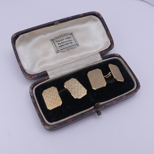 358 - A cased pair of 9ct gold Cufflinks, of rectangular form with canted corners and engine turned decora... 