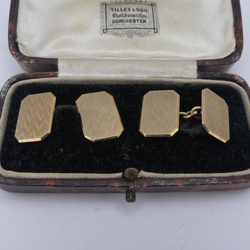 358 - A cased pair of 9ct gold Cufflinks, of rectangular form with canted corners and engine turned decora... 