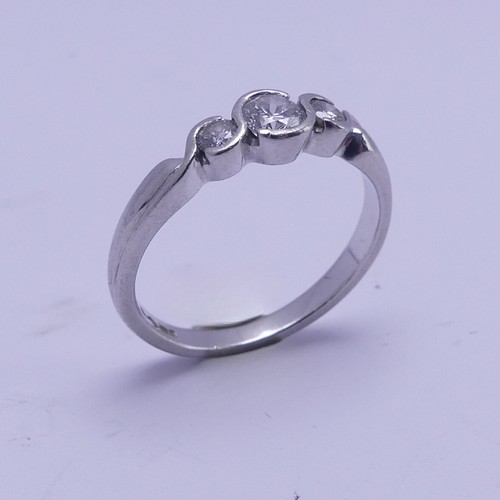 166 - A graduated three stone diamond Ring, the centre stone approx. 0.22ct, all mounted in platinum, Size... 