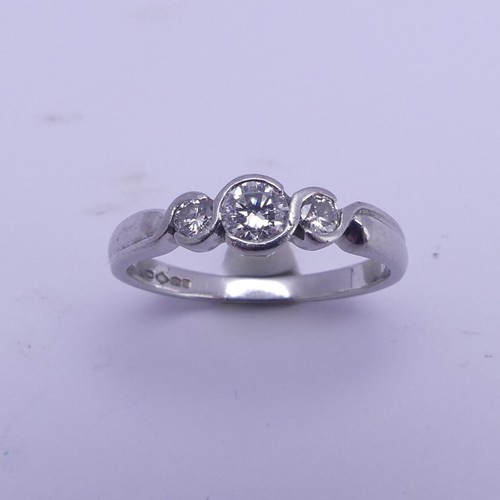 166 - A graduated three stone diamond Ring, the centre stone approx. 0.22ct, all mounted in platinum, Size... 