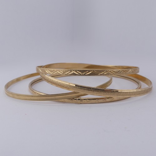 291 - Four 9ct yellow good Slave Bangles, various engraved decoration, approx. total weight 17.1g (4)... 