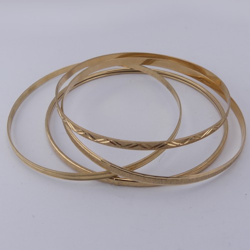 291 - Four 9ct yellow good Slave Bangles, various engraved decoration, approx. total weight 17.1g (4)... 