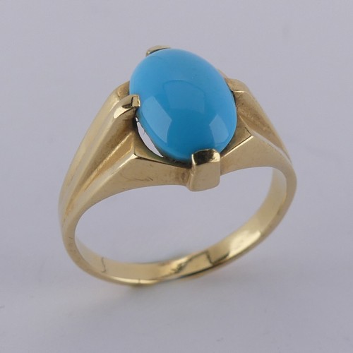 170 - An oval cabochon turquoise Ring, the stone 10mm long, four claw set in modernist yellow gold mount, ... 