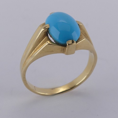 170 - An oval cabochon turquoise Ring, the stone 10mm long, four claw set in modernist yellow gold mount, ... 