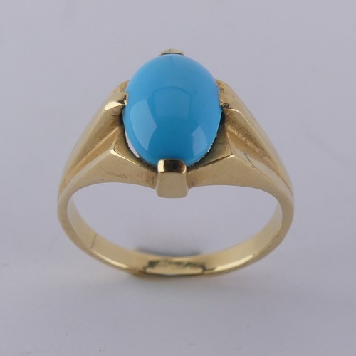 170 - An oval cabochon turquoise Ring, the stone 10mm long, four claw set in modernist yellow gold mount, ... 