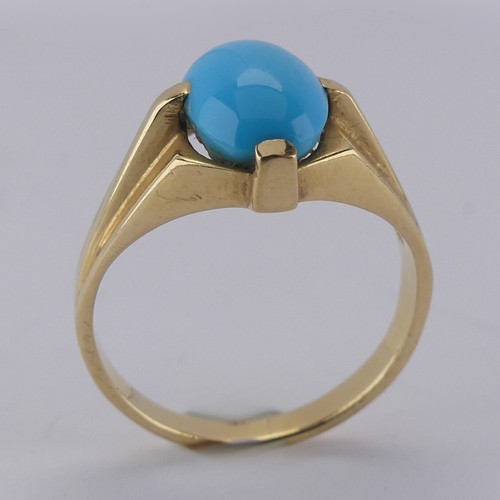 170 - An oval cabochon turquoise Ring, the stone 10mm long, four claw set in modernist yellow gold mount, ... 