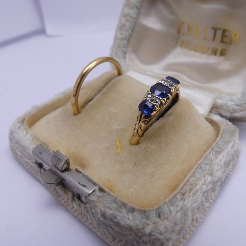 173 - A three stone sapphire Ring, the centre stone approx. 4.4mm long, each with two vertical diamonds be... 