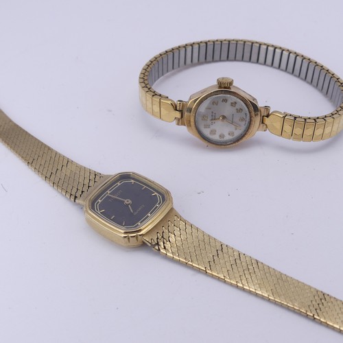 136 - A 9ct yellow gold lady's Tissot quartz Wristwatch, with black dial and integral bracelet strap, dama... 