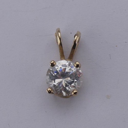 265 - A diamond solitaire Pendant, the brilliant cut stone approx. 0.2ct, on a 9ct yellow gold trace chain... 