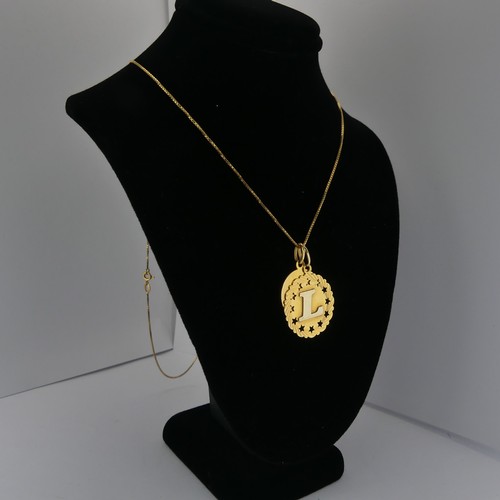 375 - An 18ct yellow gold 'Gemini' Zodiac Pendant, together with an 18ct gold pendant initialled 'L' and a... 