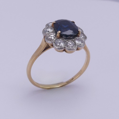 181 - A sapphire and diamond cluster Ring, the central oval facetted sapphire approx. 7.6mm x 6.4mm, surro... 