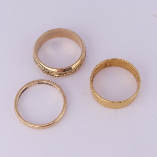 183 - A 22ct yellow gold textured Band, 5.9mm wide, Size Q½, 5.6g, together with a narrow 9ct gold ... 