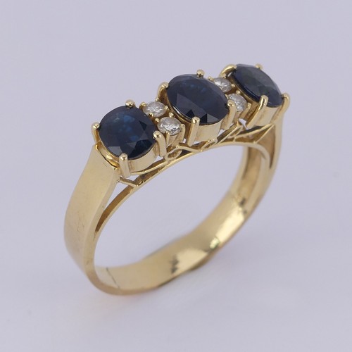 190 - A sapphire and diamond Ring, the synthetic oval facetted sapphires with two small diamonds set verti... 