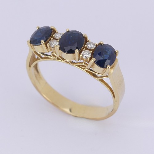 190 - A sapphire and diamond Ring, the synthetic oval facetted sapphires with two small diamonds set verti... 