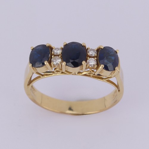 190 - A sapphire and diamond Ring, the synthetic oval facetted sapphires with two small diamonds set verti... 